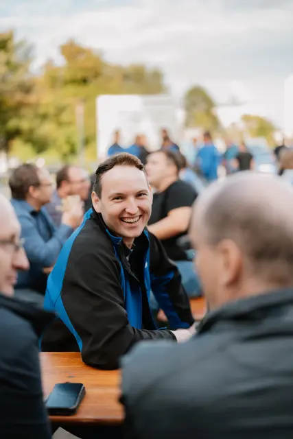Lachender Mitarbeiter beim Sommerfest